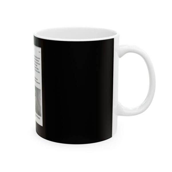 Black mug with white handle and text.