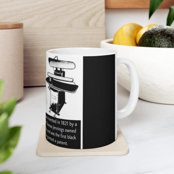 White mug with black iron illustration.