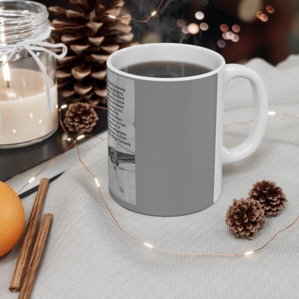 White mug with gray design and coffee.