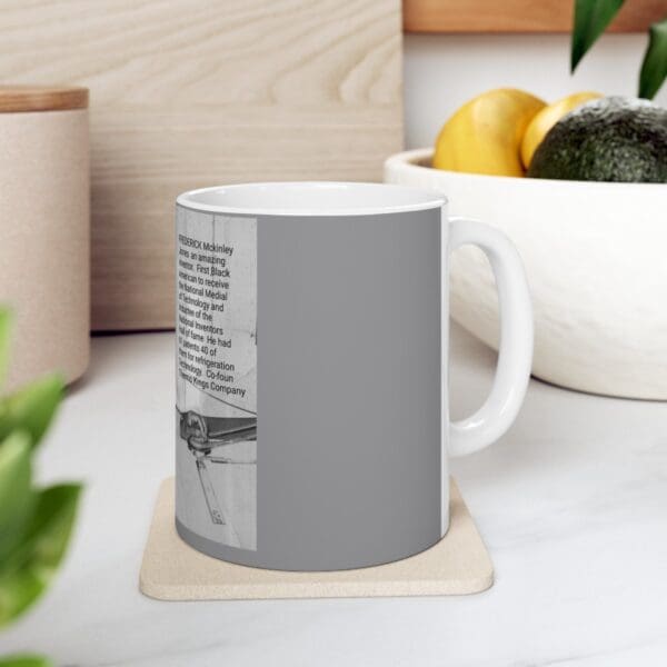 Gray mug with text about Frederick McKinley Jones.