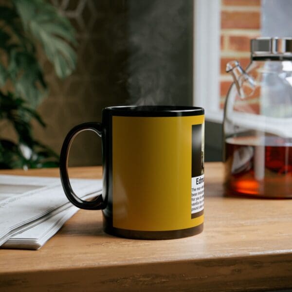 Black mug with yellow text and steam.