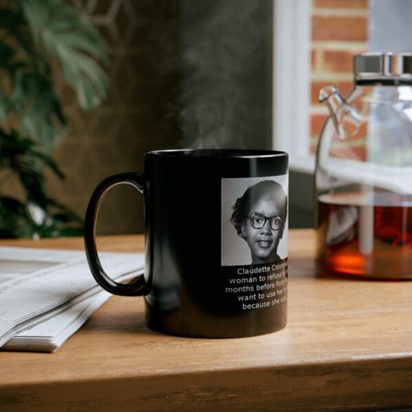 Black mug with Claudette Colvin's image.