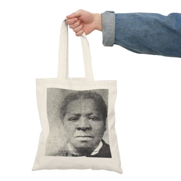 White tote bag with black and white portrait.