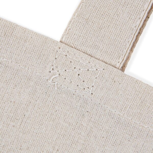 Close-up of a beige canvas tote bag.