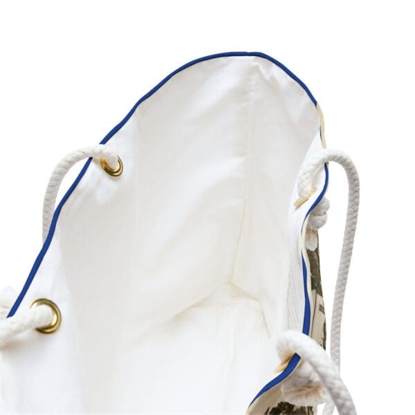 White tote bag with blue trim and rope handles.