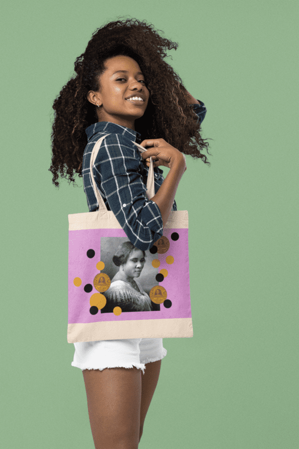 Woman with tote bag featuring a portrait.