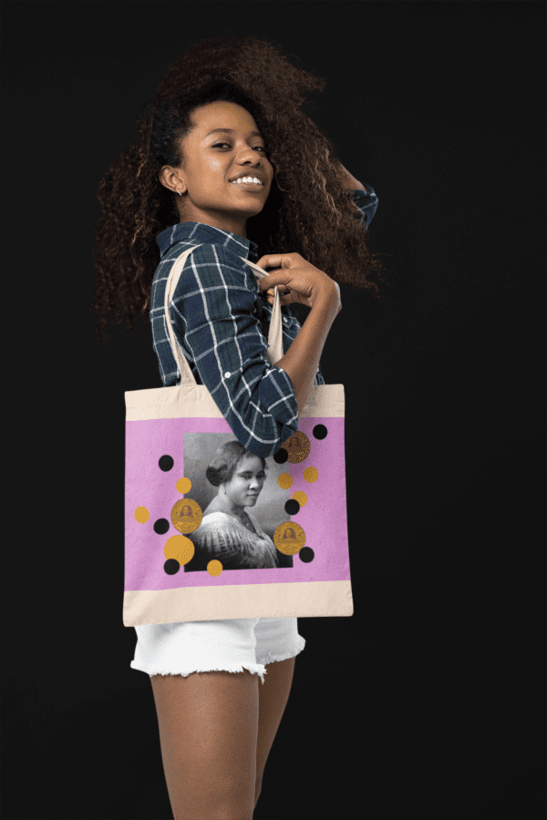 Woman with tote bag featuring a portrait.