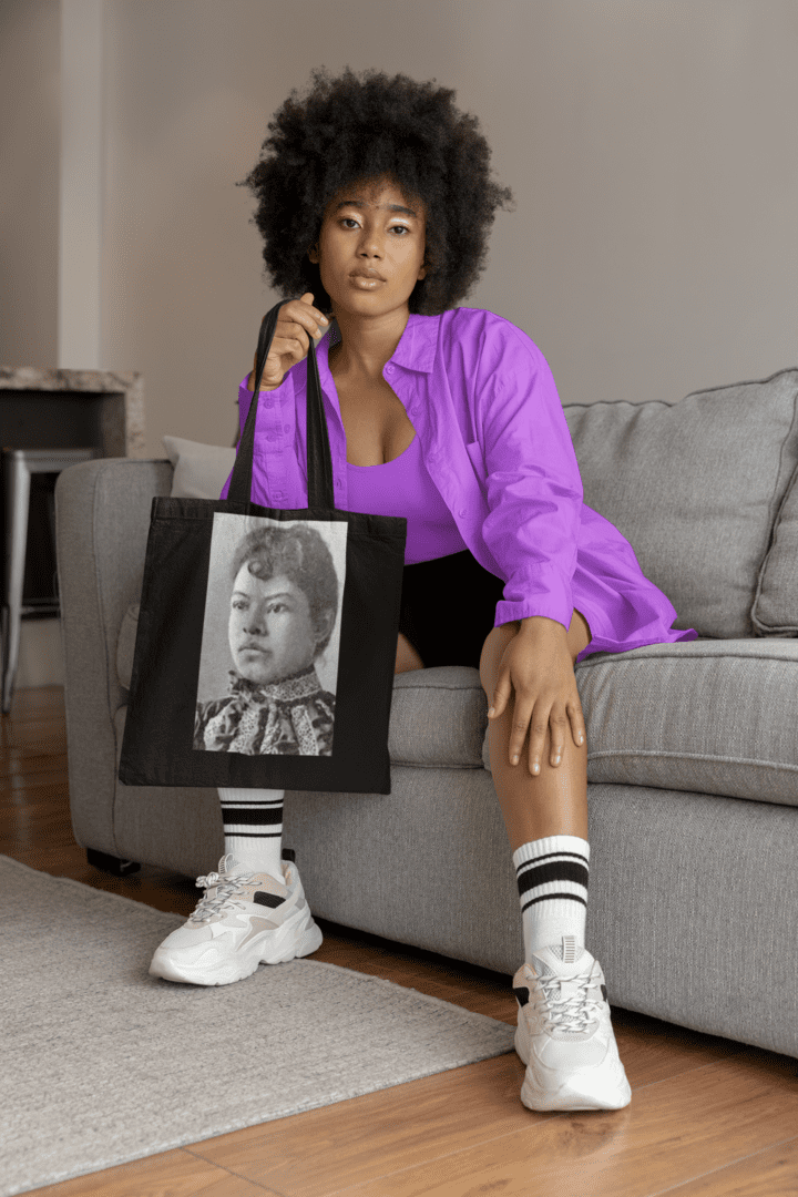 Woman in purple shirt with tote bag.