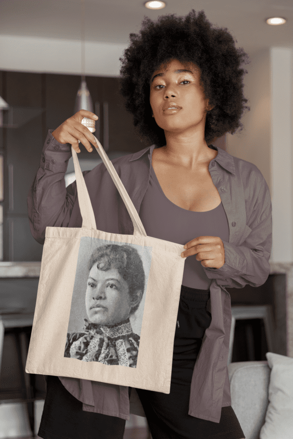 Woman holding tote bag with portrait.