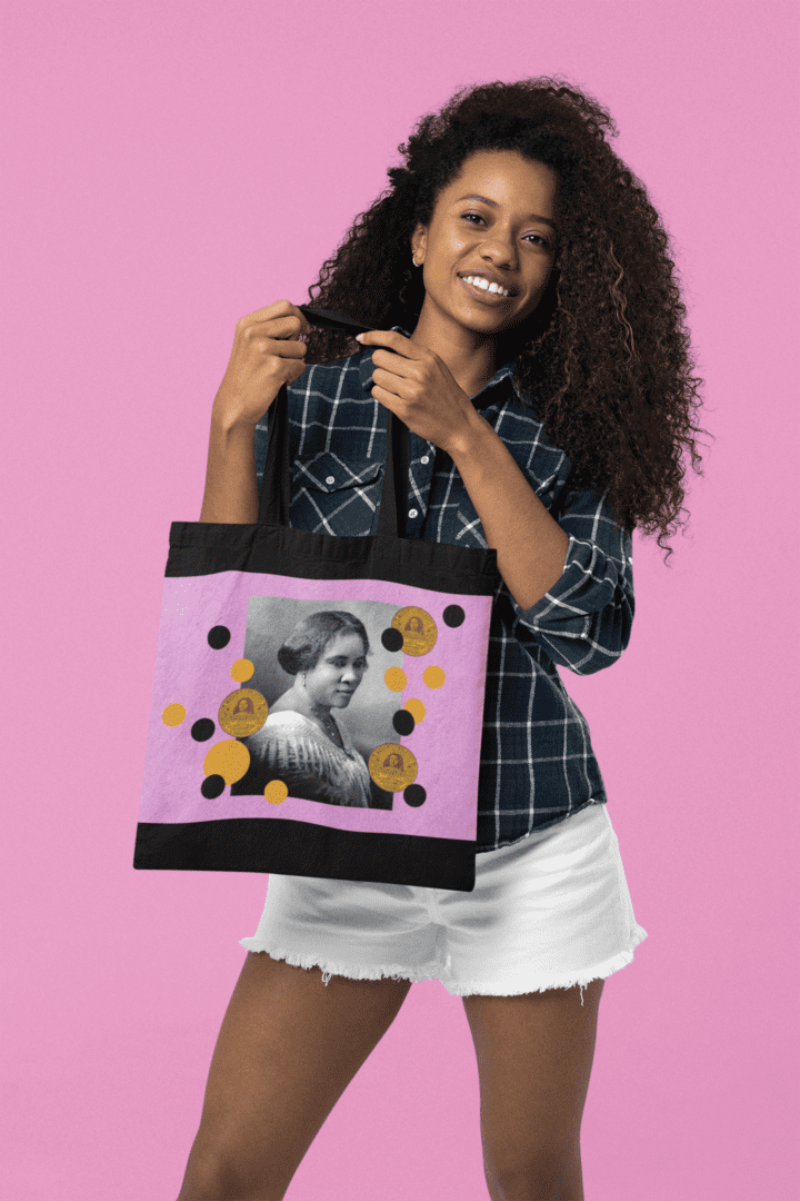 Woman holding a tote bag with a portrait.