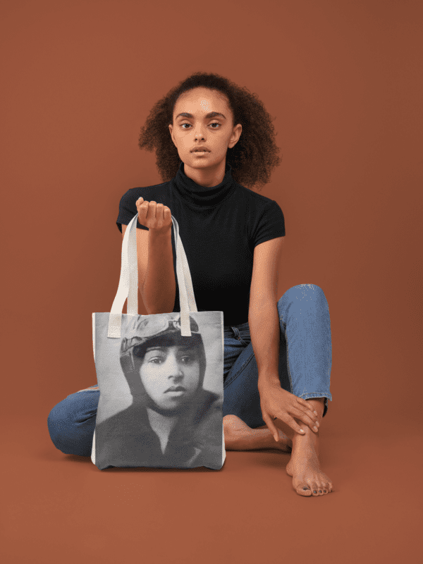 A woman holding a tote bag with a pilot on it.