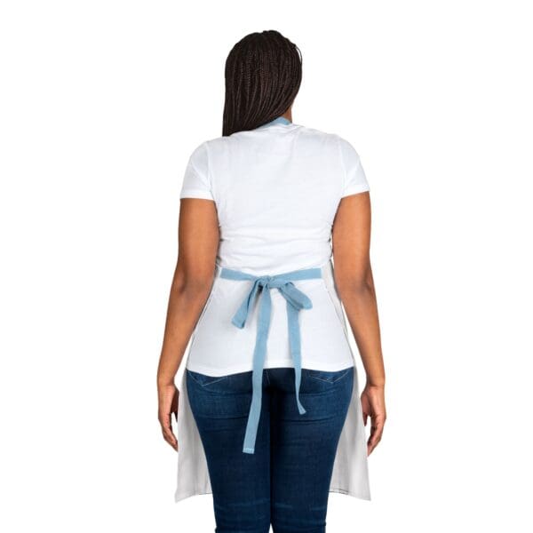 A woman wearing an apron and jeans