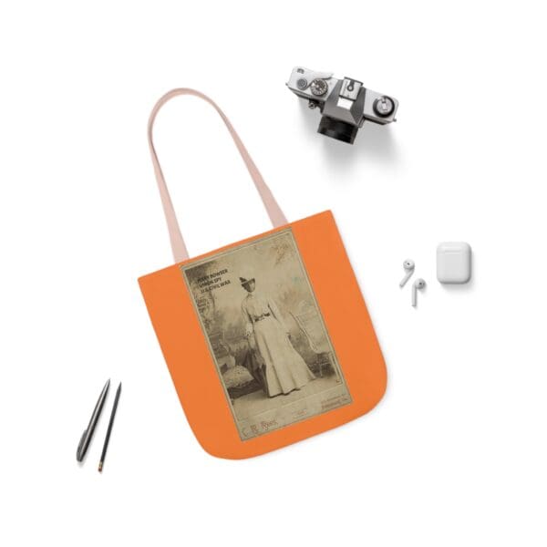 An orange tote bag with a picture of a woman.