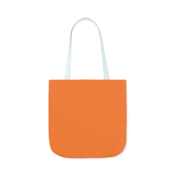 A bag that is orange and has white handles.