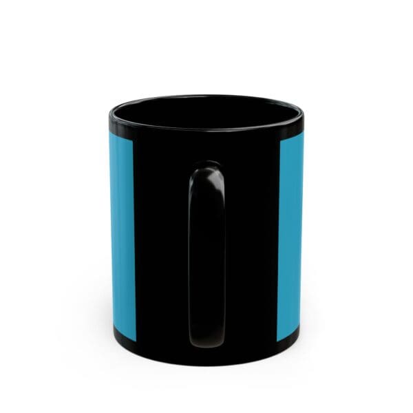 A black and blue mug is sitting on the table.