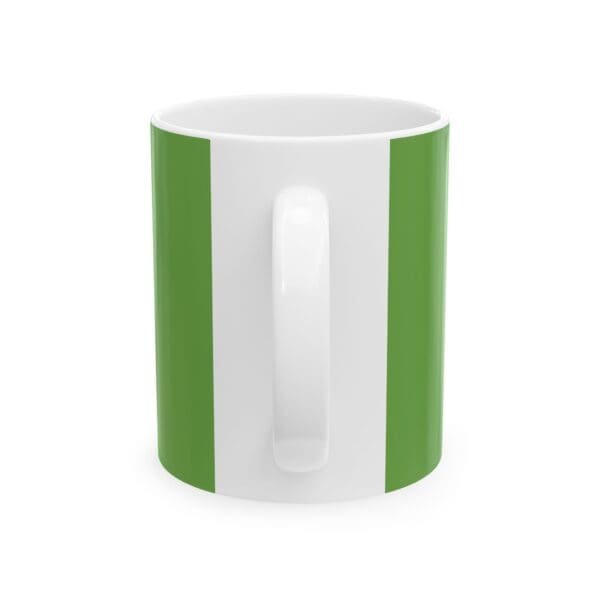 A green and white mug with the handle up.