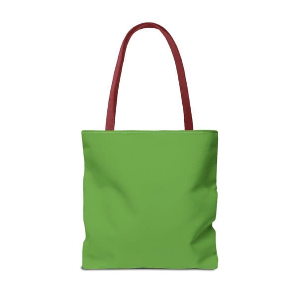 A green tote bag with red handles and an orange handle.