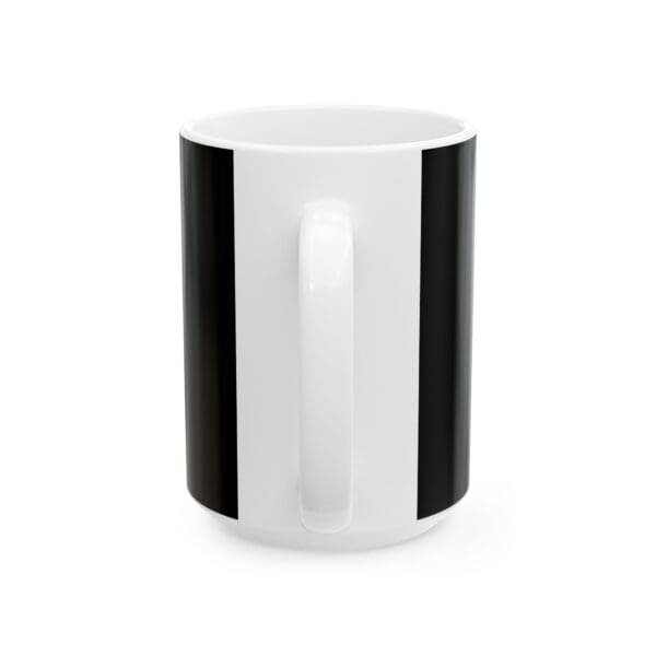 A white and black coffee mug is sitting on the table.