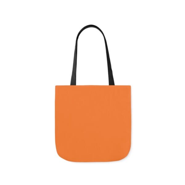 A bag with an orange background and black handles.