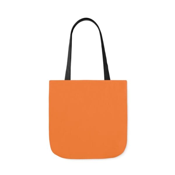 A bag with an orange background and black handles.