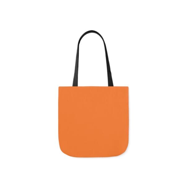 A bag that is orange and has black handles.