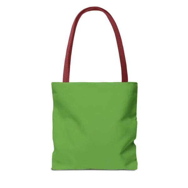 A green tote bag with red handles and an orange handle.