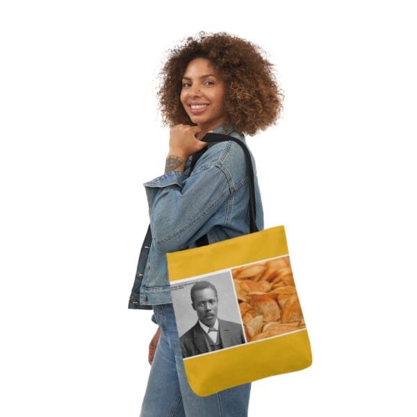 A woman holding onto a bag with an image of a man.